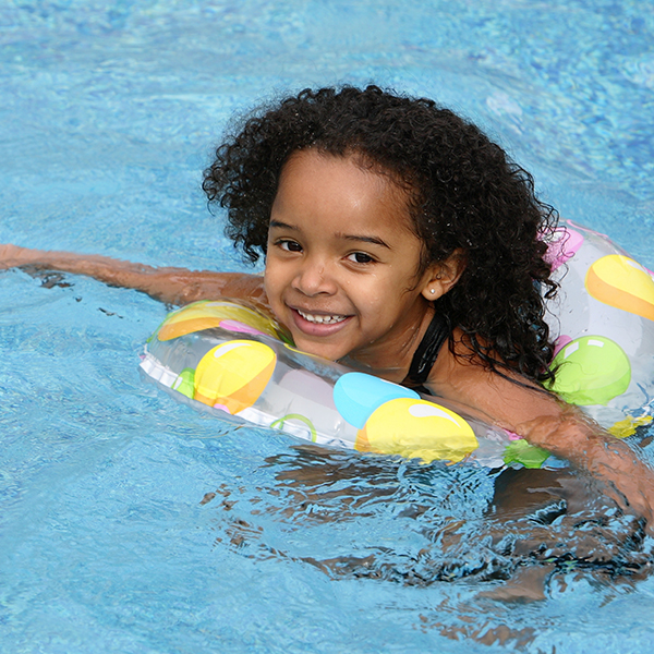 girl floating around in tub in pool